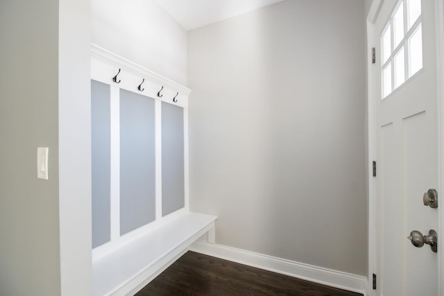 mudroom featuring dark wood finished floors and baseboards