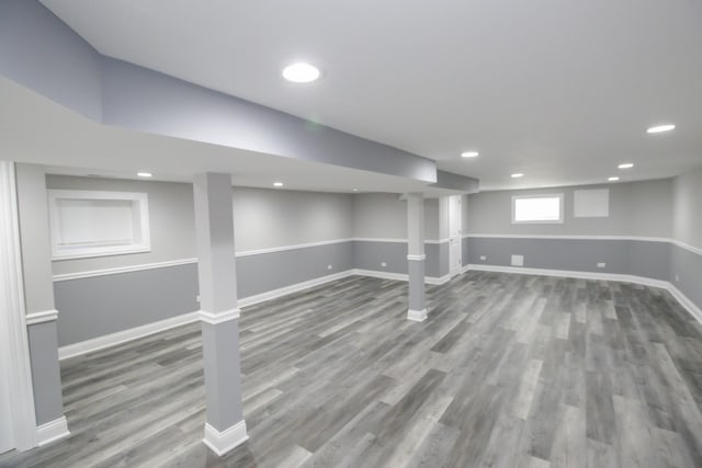 below grade area featuring recessed lighting, wood finished floors, and baseboards