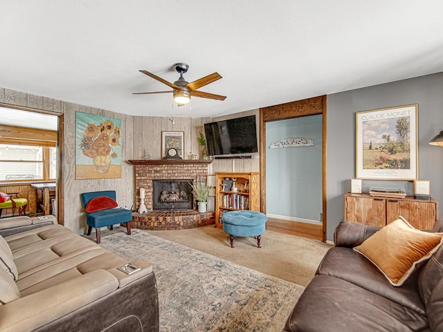 living room with ceiling fan, a fireplace, and baseboards