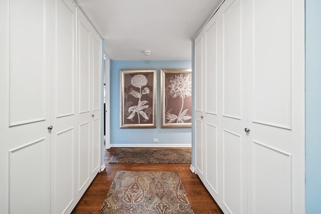 hall with baseboards and dark wood finished floors