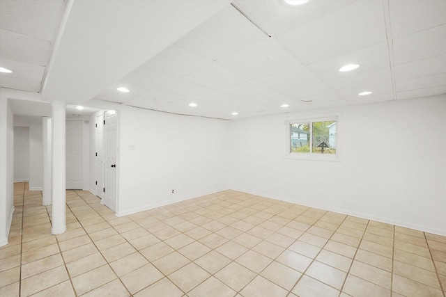 below grade area featuring recessed lighting, a drop ceiling, and baseboards