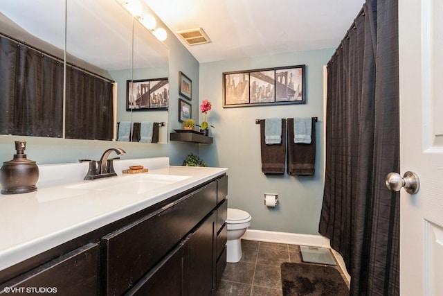 bathroom with baseboards, visible vents, toilet, tile patterned floors, and vanity