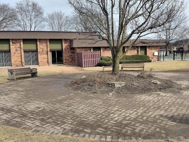 exterior space with fence and decorative driveway