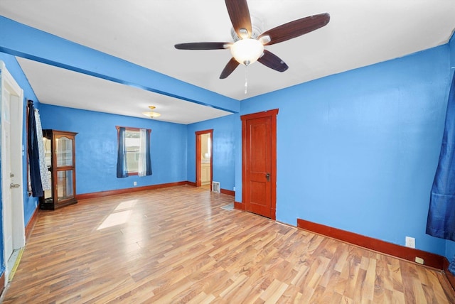 unfurnished room with baseboards, ceiling fan, and light wood finished floors