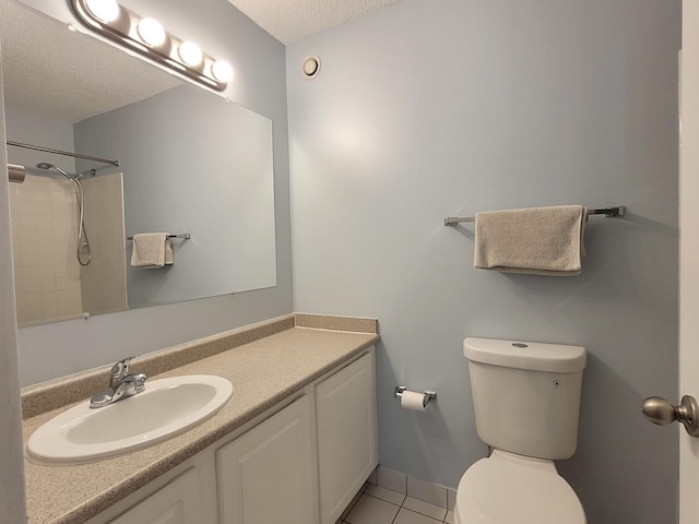 full bathroom featuring tile patterned floors, toilet, vanity, a textured ceiling, and walk in shower