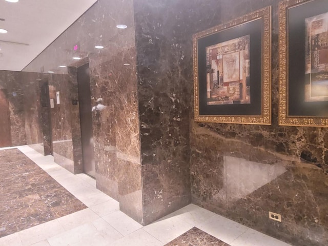 bathroom with tile walls