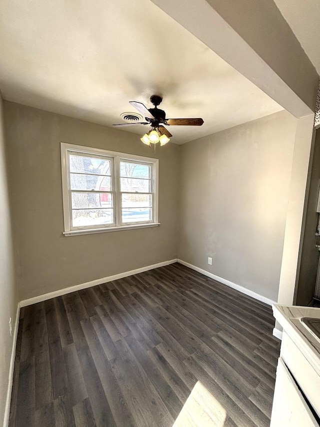 empty room with ceiling fan, baseboards, and dark wood finished floors