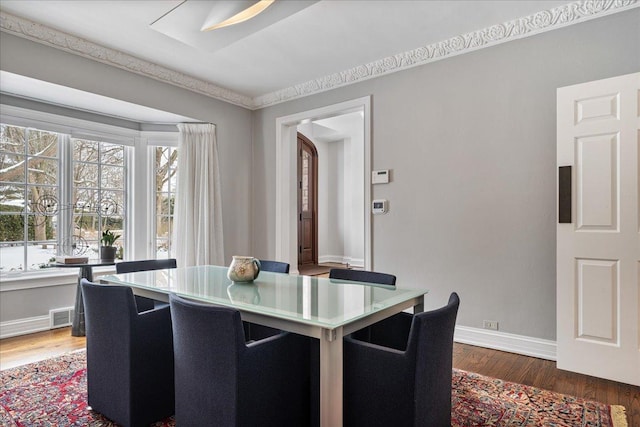 dining area with visible vents, baseboards, and dark wood finished floors