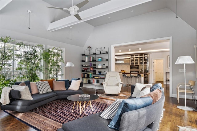 living room with wood finished floors, a ceiling fan, and high vaulted ceiling