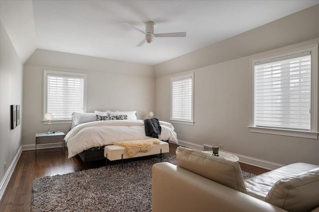 bedroom featuring a ceiling fan, vaulted ceiling, baseboards, and dark wood-style flooring