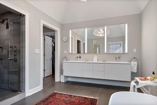 full bath with a shower stall, double vanity, and baseboards