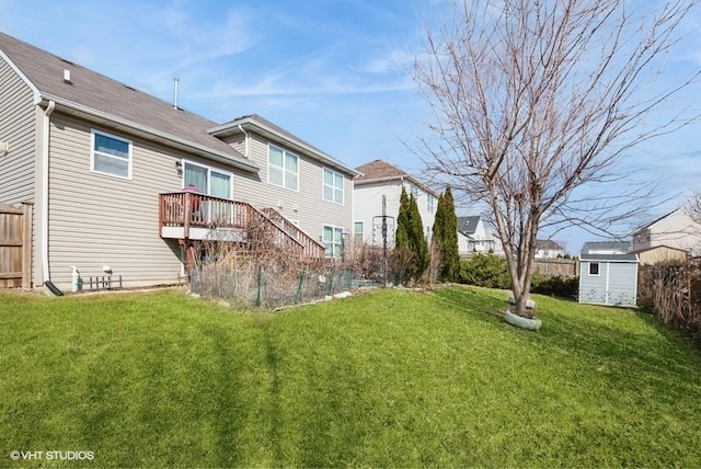 back of property with a storage shed, a lawn, stairs, fence, and an outdoor structure