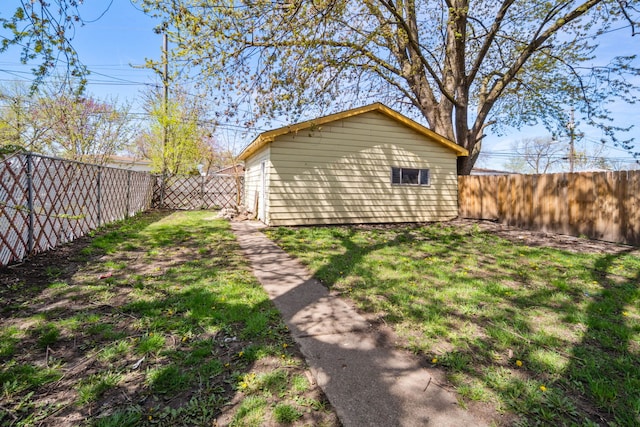 view of yard with a fenced backyard and an outbuilding