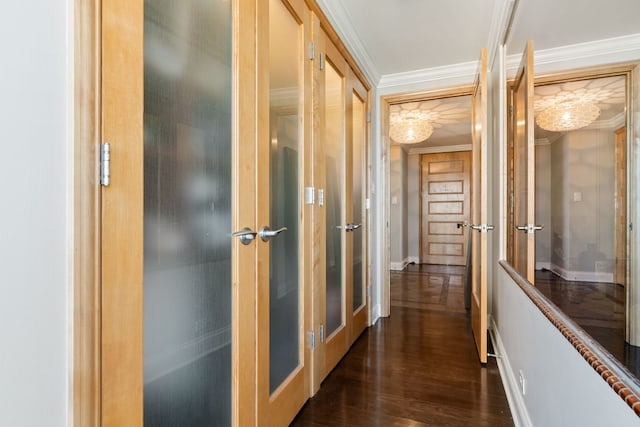 hallway featuring baseboards, ornamental molding, and dark wood-style flooring