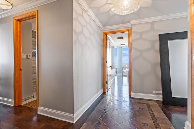 hallway with ornamental molding and baseboards