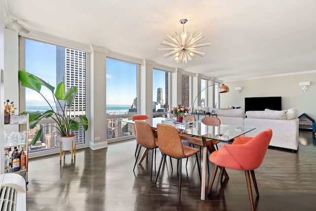 dining space with a chandelier, expansive windows, ornamental molding, and wood finished floors