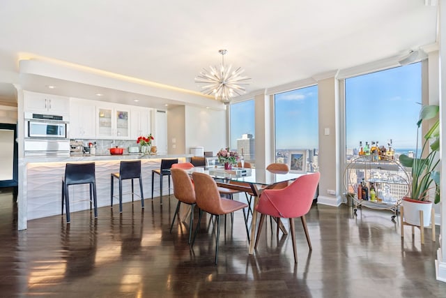 dining room featuring floor to ceiling windows, a chandelier, and dark wood-style flooring