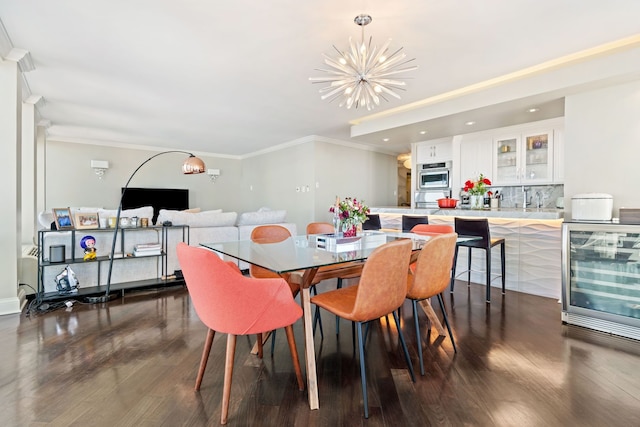 dining area with ornamental molding, beverage cooler, dark wood-type flooring, and an inviting chandelier