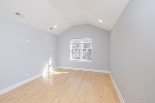 unfurnished room featuring light wood finished floors, visible vents, and baseboards