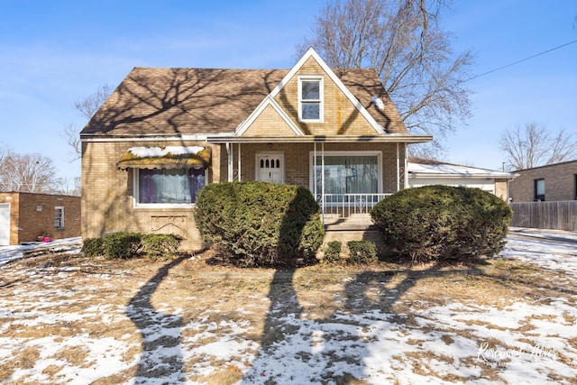 view of front of property with brick siding and fence