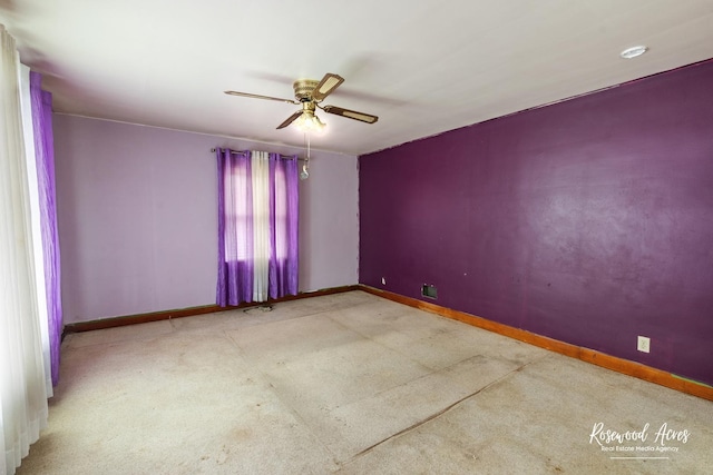 spare room featuring baseboards and a ceiling fan