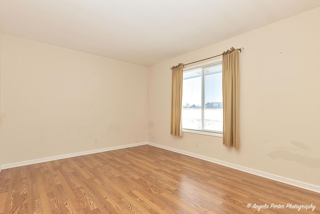 unfurnished room featuring light wood-style floors and baseboards