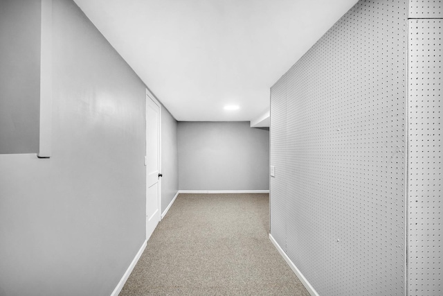 corridor featuring carpet and baseboards