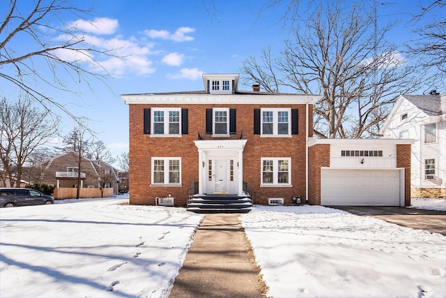 view of front of home featuring a garage and brick siding