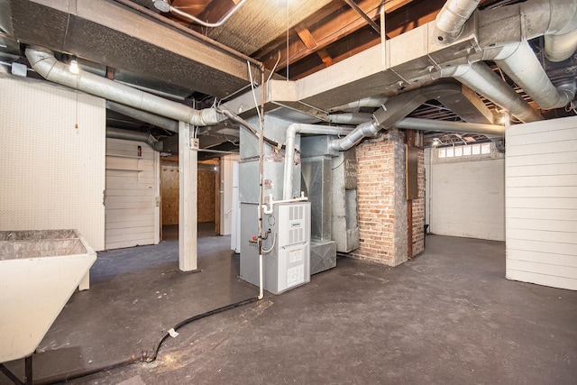 below grade area with a sink and heating unit