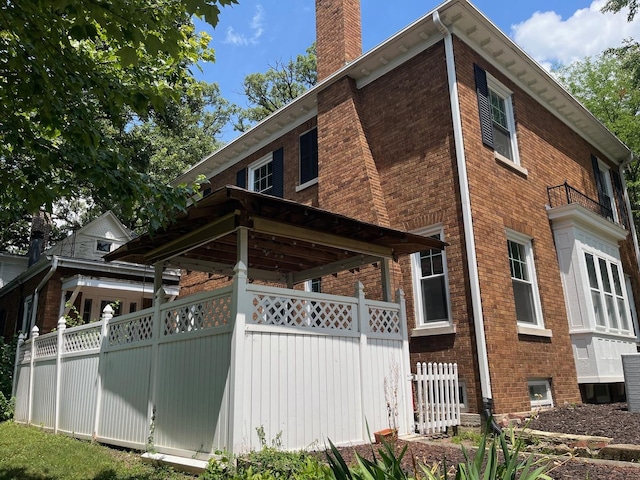 895 S Greenwood Ave, Kankakee, IL 60901 - view of home's exterior featuring brick siding and a chimney