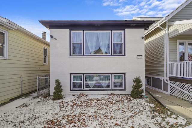 back of property with brick siding and fence