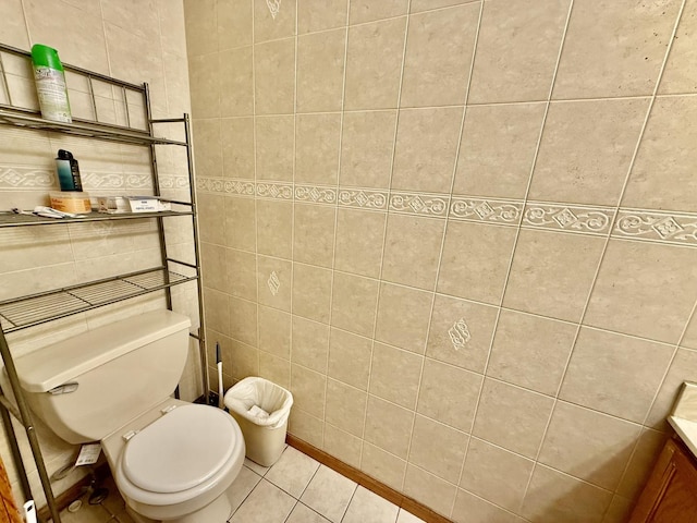 bathroom featuring toilet, tile walls, and tile patterned floors