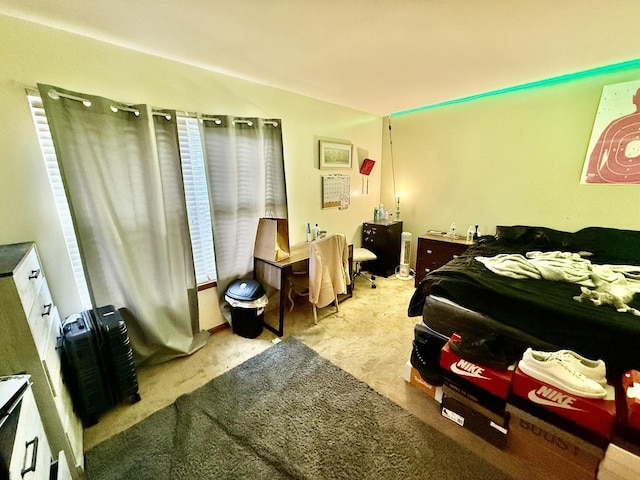 carpeted bedroom with lofted ceiling