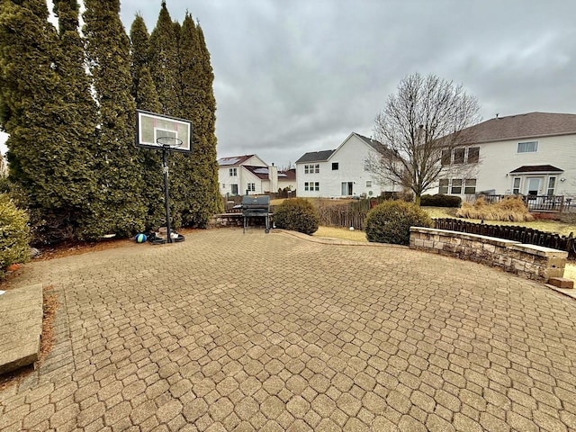 exterior space with a residential view, a patio area, and fence