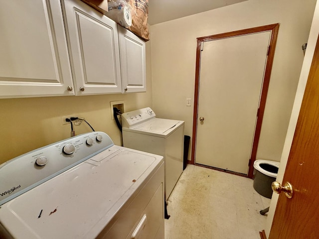 laundry area with washing machine and dryer, cabinet space, and light floors