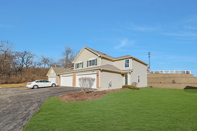 view of front facade with driveway, a garage, fence, and a front yard