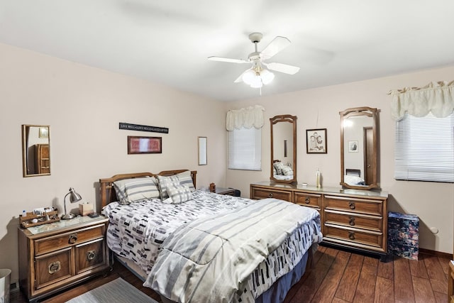 bedroom with baseboards, a ceiling fan, and dark wood-type flooring