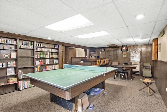 game room with light carpet and wood walls