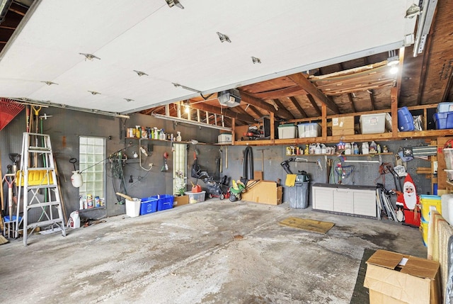 garage with a workshop area and a garage door opener