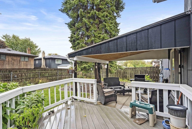 wooden terrace featuring a fenced backyard and an outdoor living space