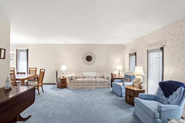 living area with carpet floors, plenty of natural light, and wallpapered walls