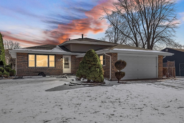 ranch-style home with an attached garage and brick siding