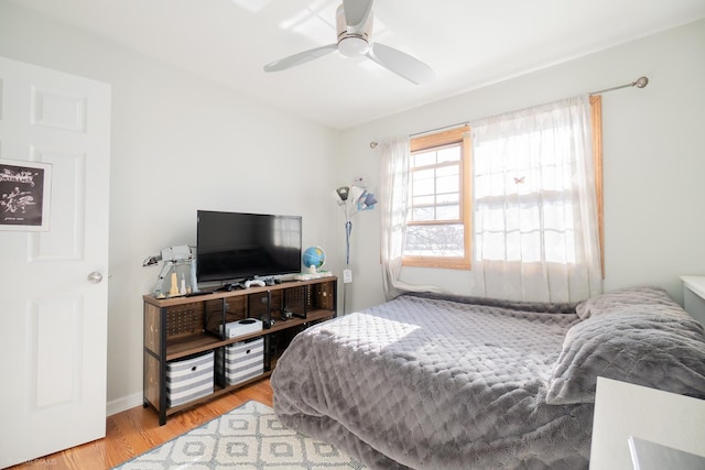 bedroom with light wood-style floors and a ceiling fan