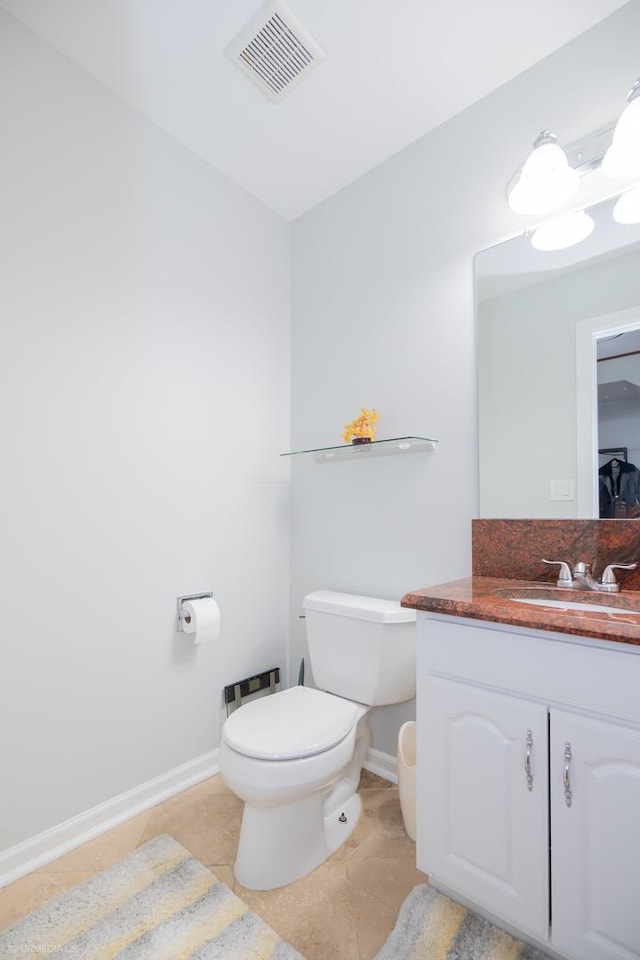 half bath featuring visible vents, toilet, vanity, tile patterned flooring, and baseboards