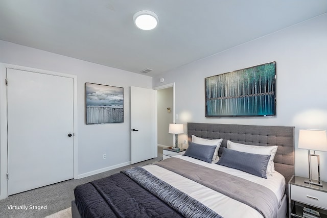 carpeted bedroom with visible vents and baseboards