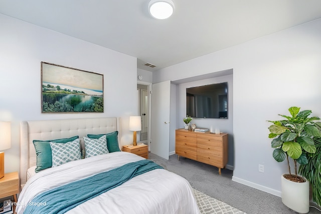 carpeted bedroom featuring visible vents and baseboards