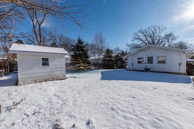 yard covered in snow featuring central AC unit