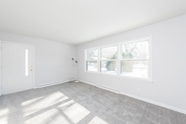 empty room featuring light carpet, a baseboard radiator, visible vents, and baseboards