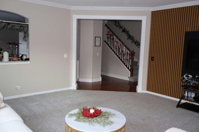 carpeted living area featuring crown molding, stairway, and baseboards