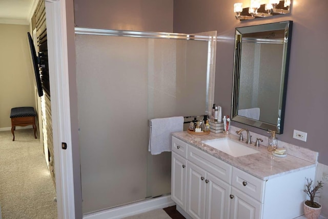 full bathroom featuring a chandelier, baseboards, a shower stall, and vanity